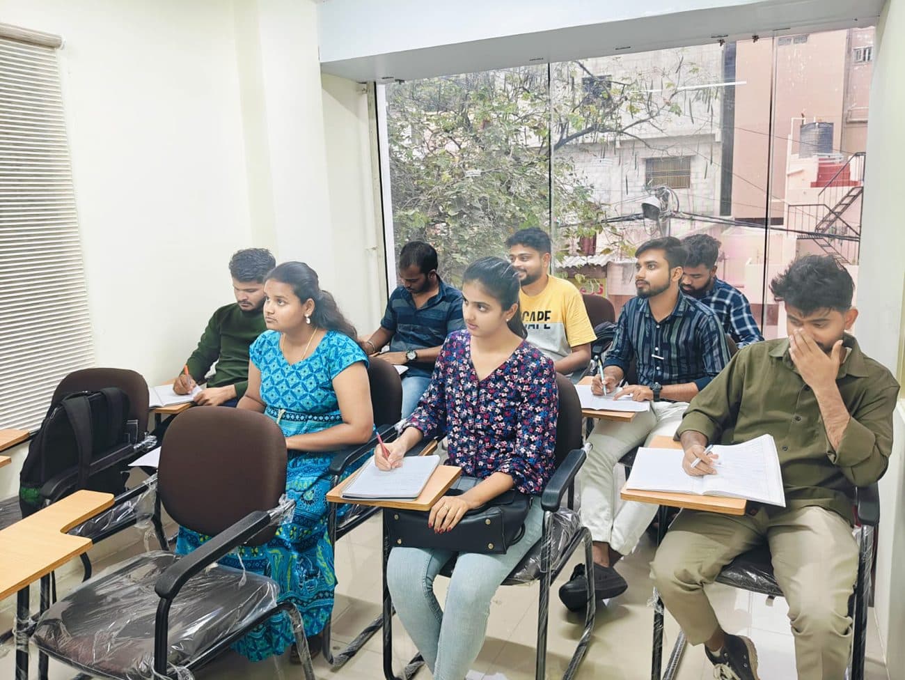 Six Cadspro students taking notes during a classroom session